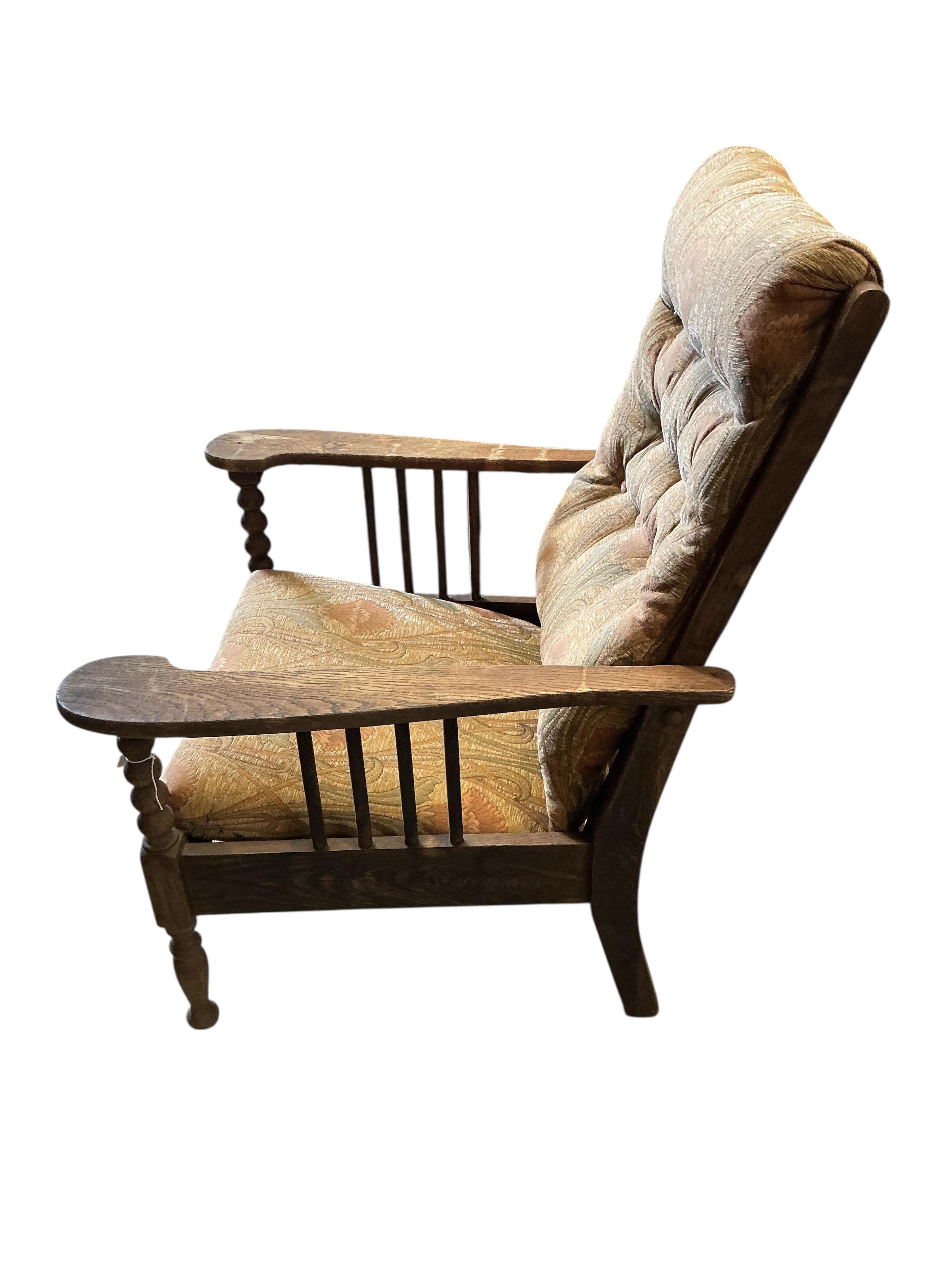 A pair of Liberty style Arts and Crafts oak reclining armchairs and an oak octagonal occasional table